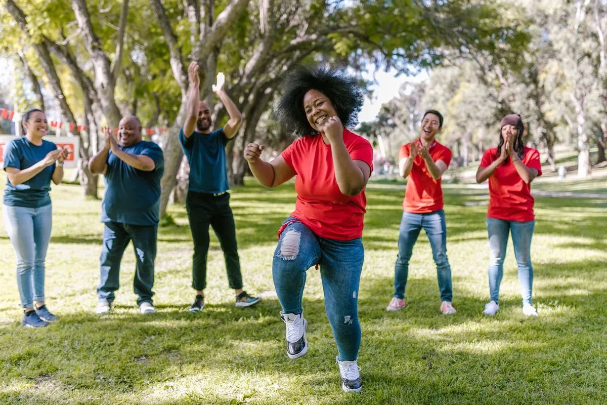 A joyful group playing a team building game outdoors
