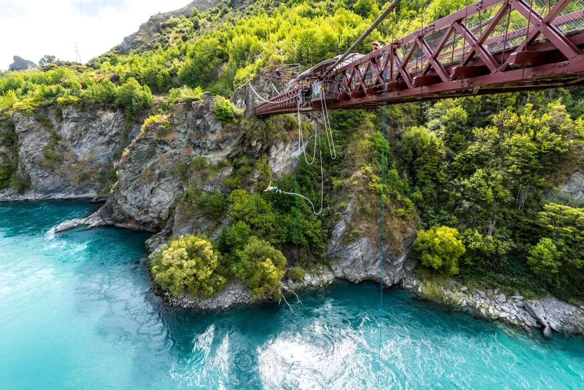 A bungee jump platform on a bridge above a turquoise river