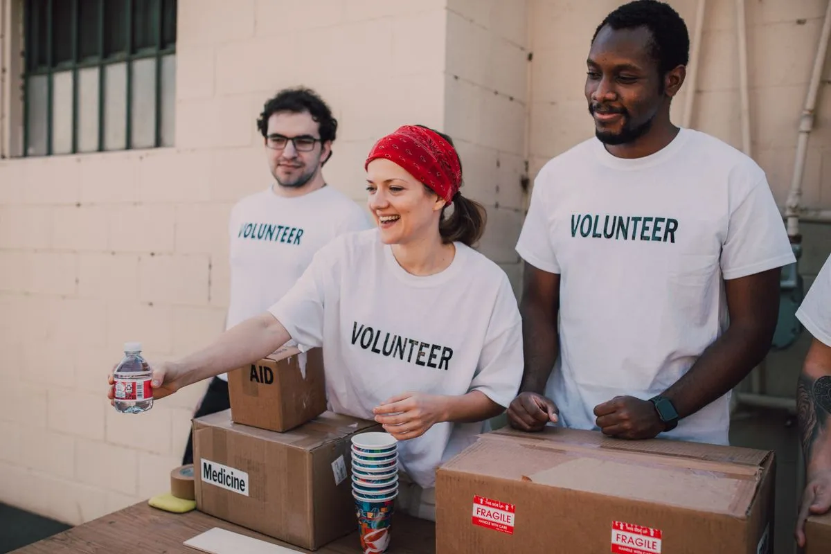 Volunteers distributing aid at an outdoor donation center.