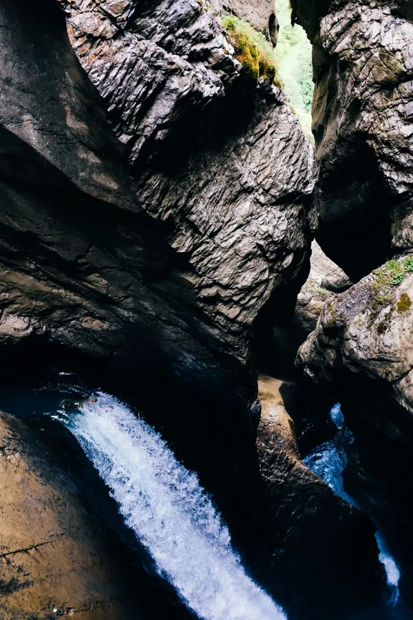A waterfall running through a rocky canyon