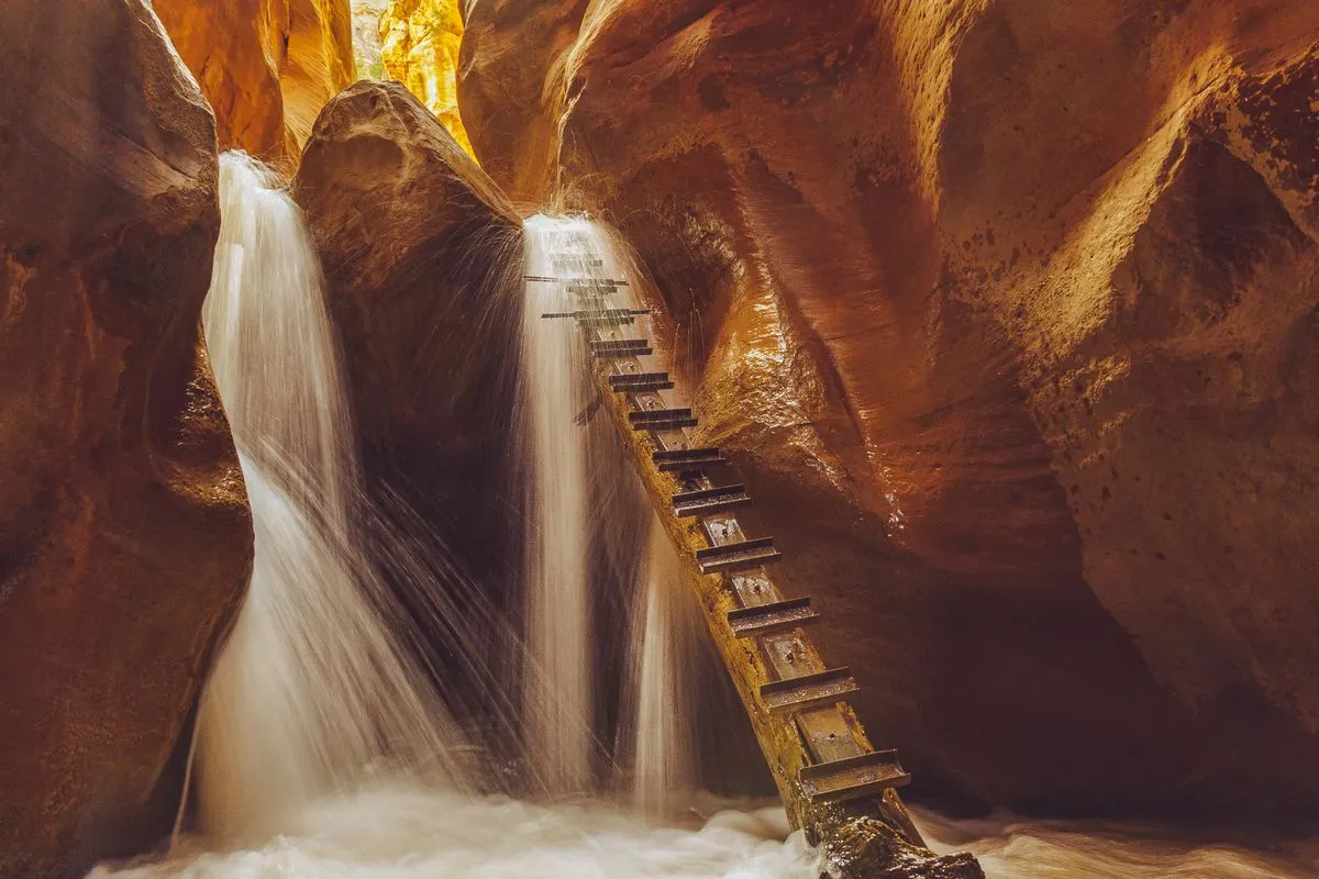 A narrow canyon waterfall with a wooden ladder