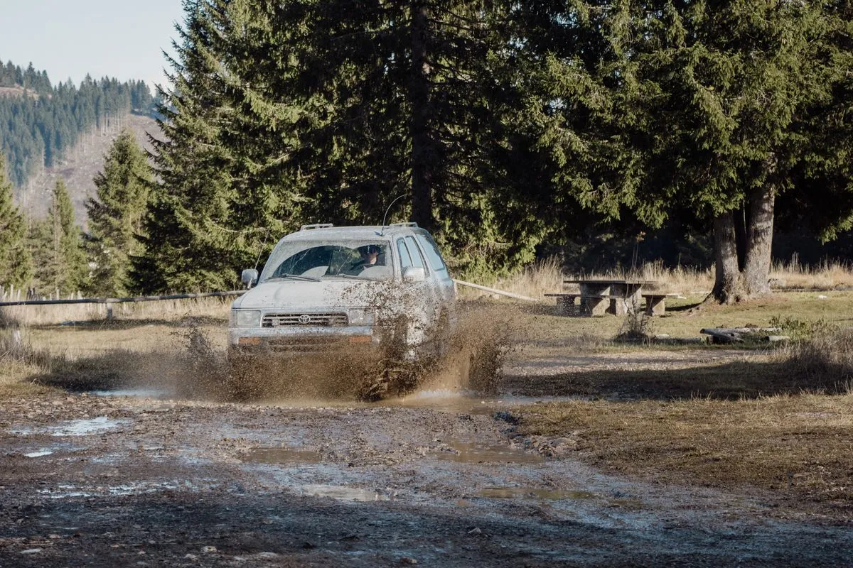 Toyota 4Runner on a muddy off-road trail in Veneto, Italy.