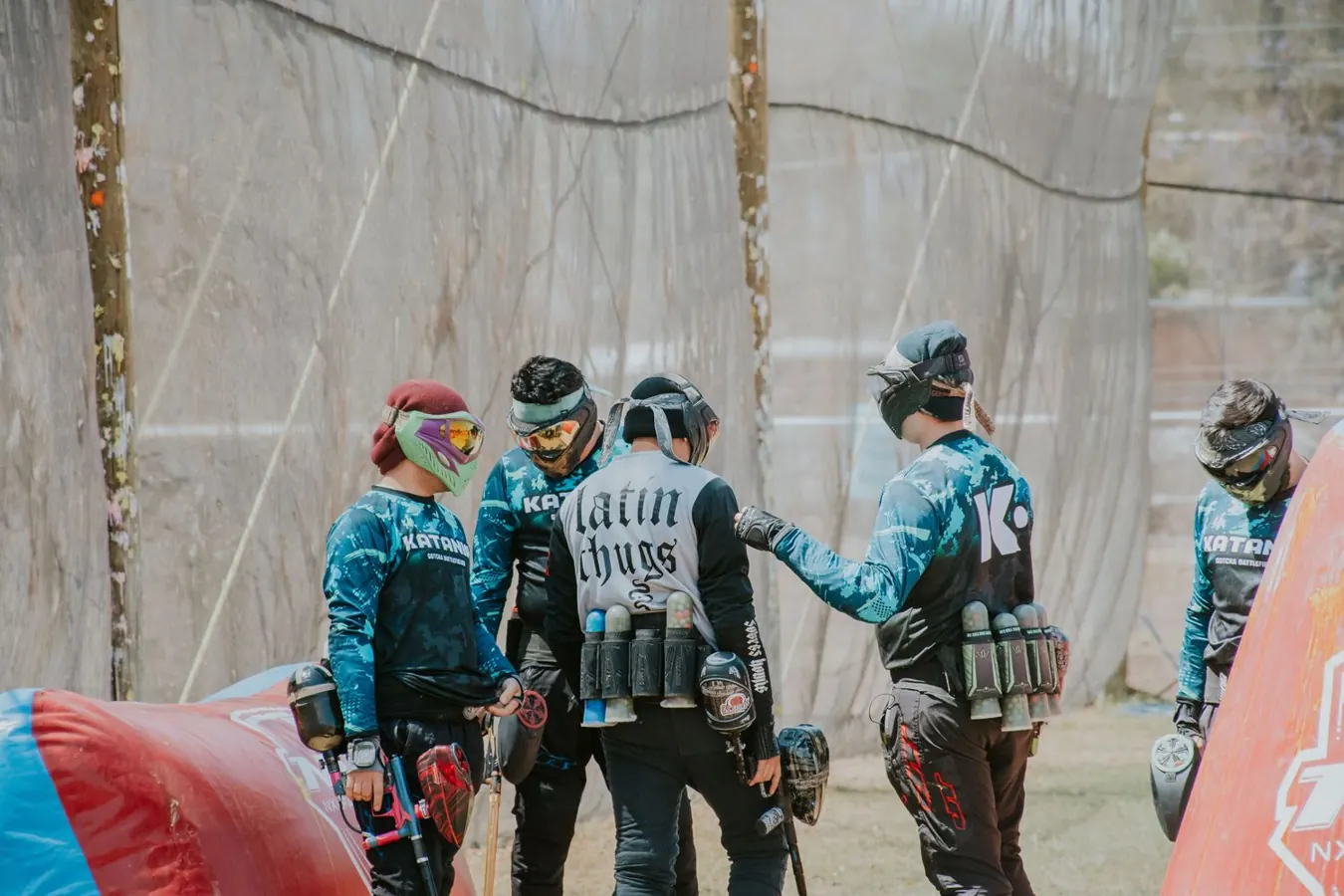 A team of paintball players planning a game outdoors