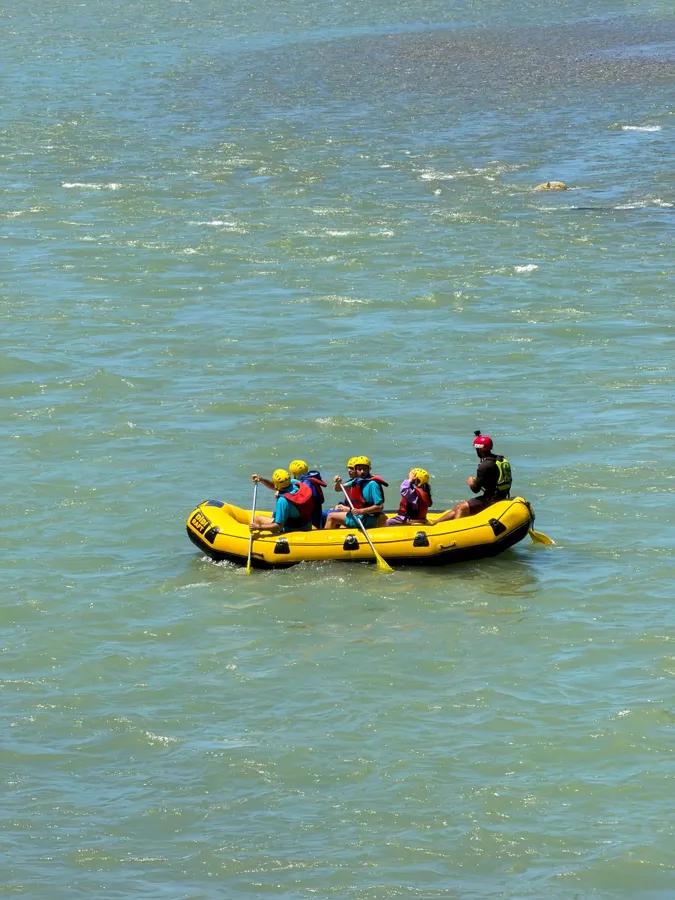 Group enjoying white-water rafting adventure on a river.